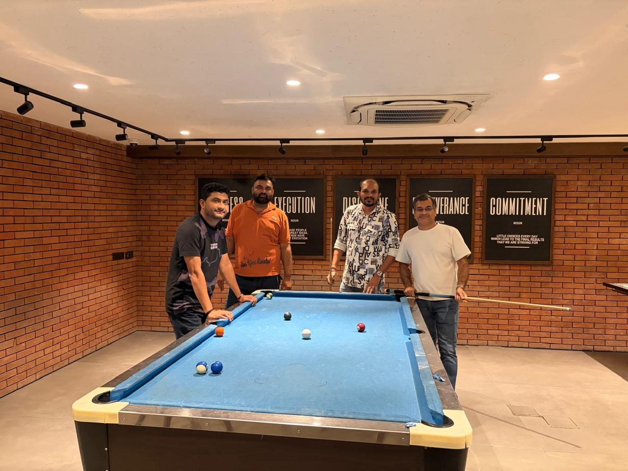 Team lining up a shot on the snooker table